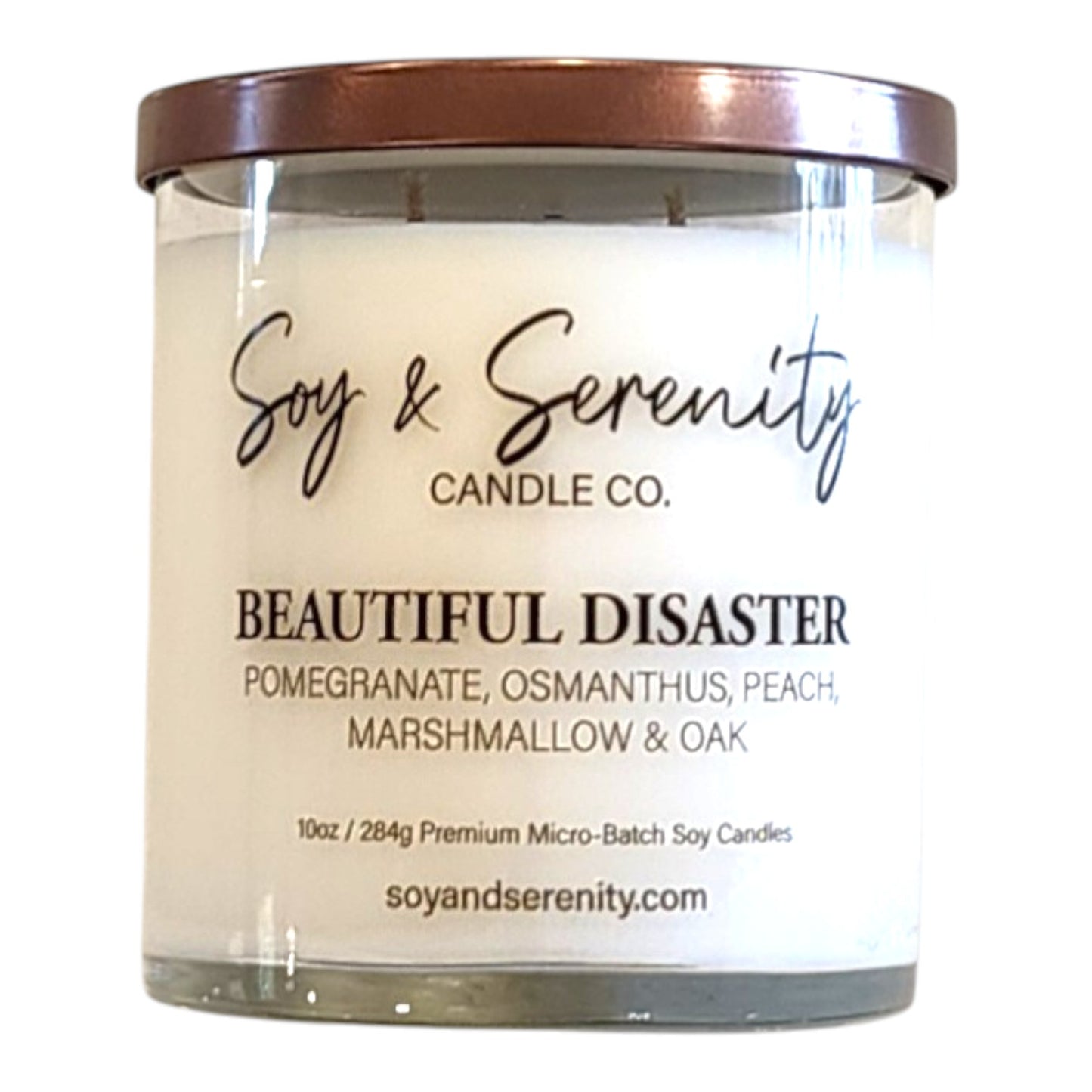 Beautiful Disaster peach candle in a clear glass jar on a white background.