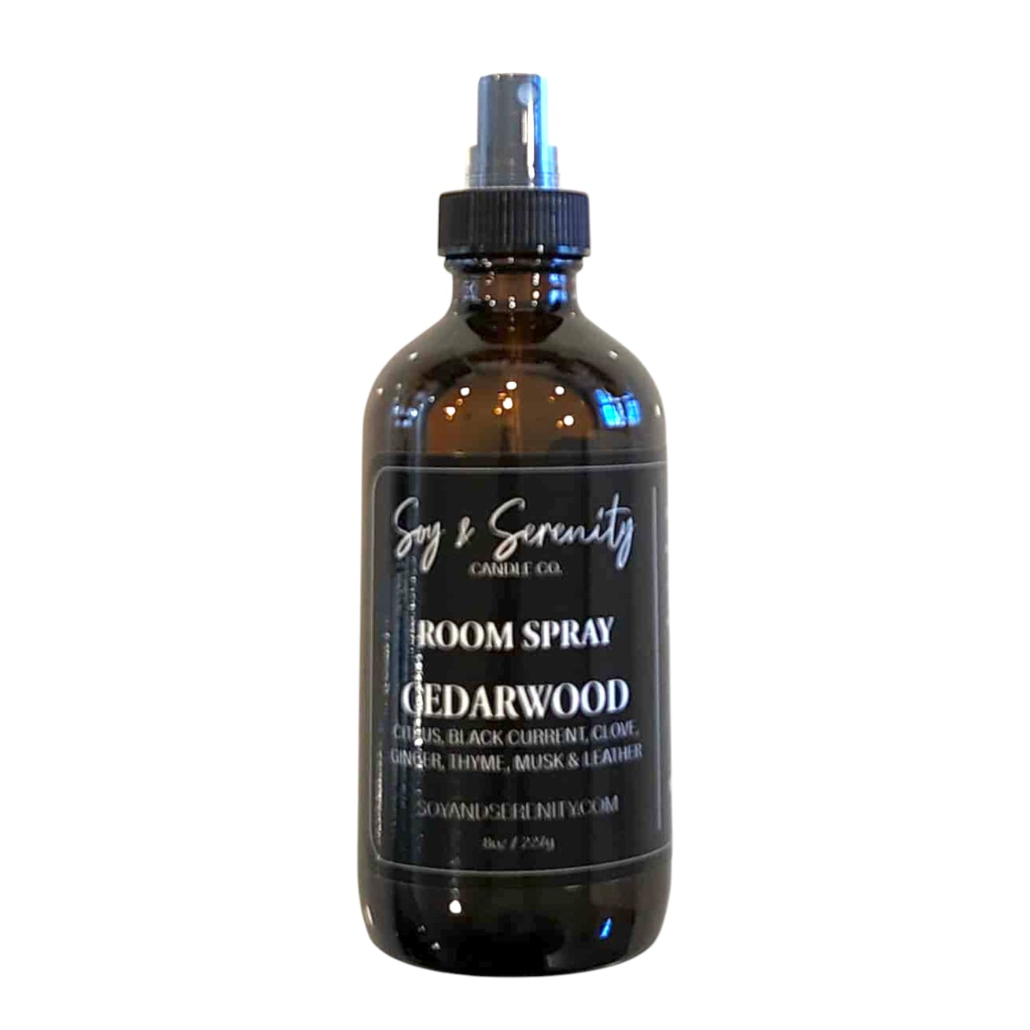 Room spray with forest-inspired cedar, herbs, and warm wood notes. Natural air freshener on white background