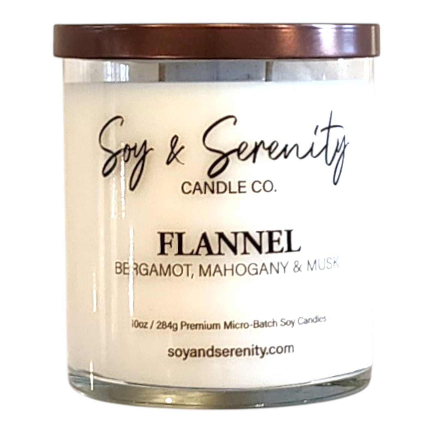 Flannel bergamot soy candle in a clear glass jar on a white background, mahogany candle.