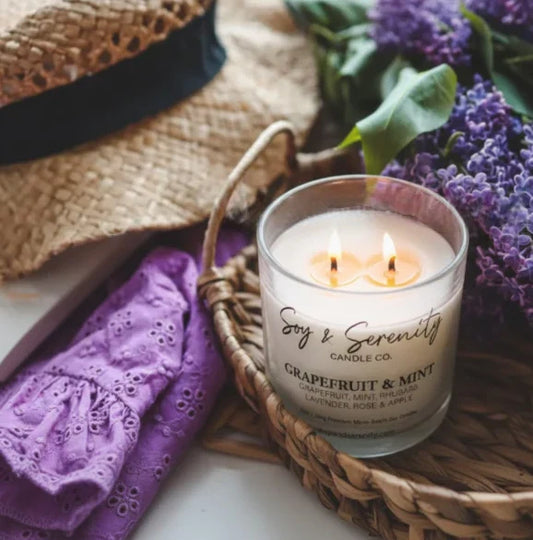 Grapefruit and mint soy candle styled with spring flowers and woven basket in a bright, fresh home setting