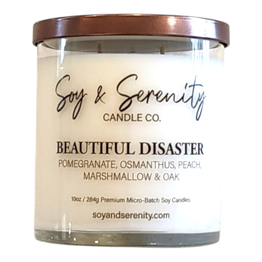 Beautiful Disaster peach candle in a clear glass jar on a white background.