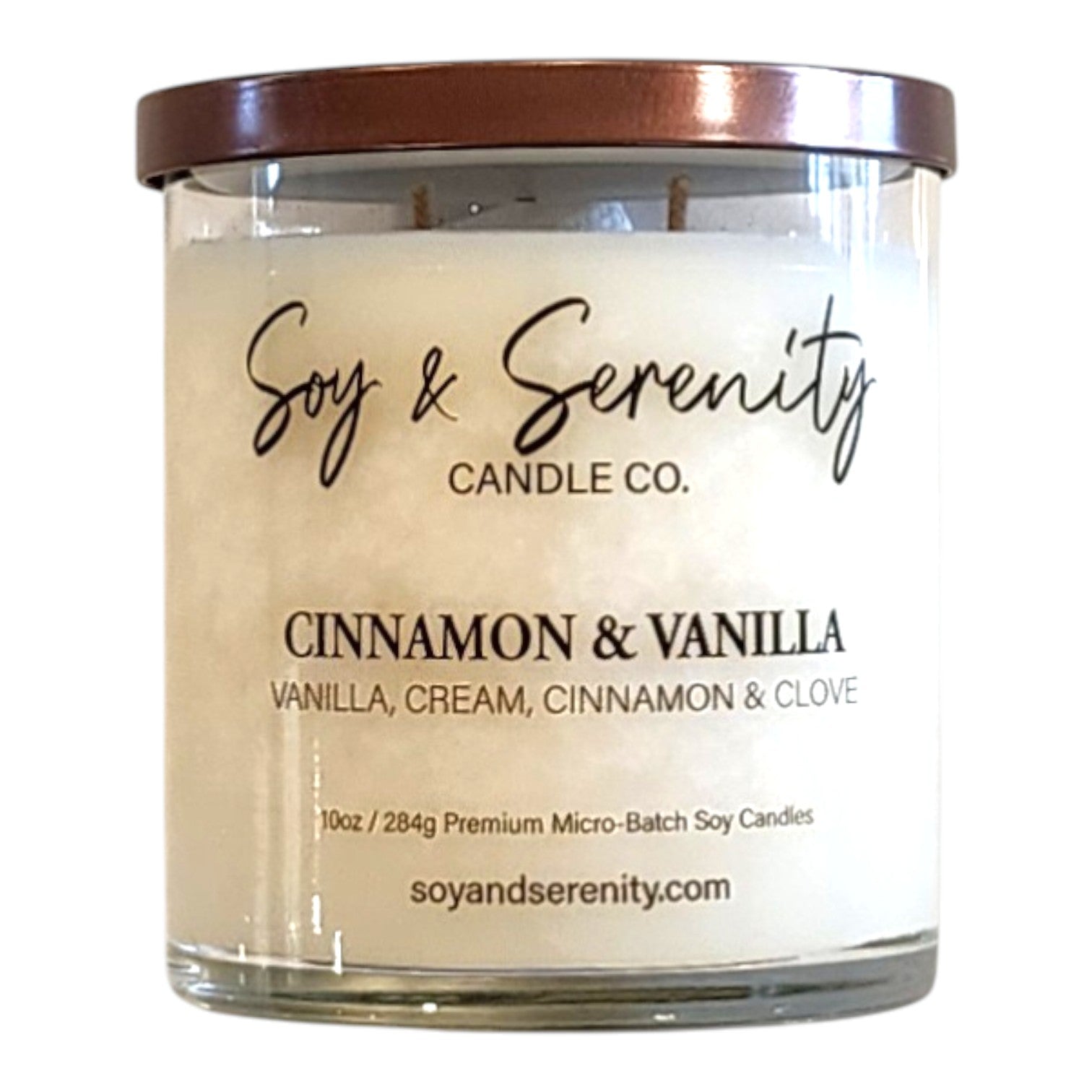 Cinnamon and Vanilla soy candle in a clear glass jar on a white background, warm vanilla candle.