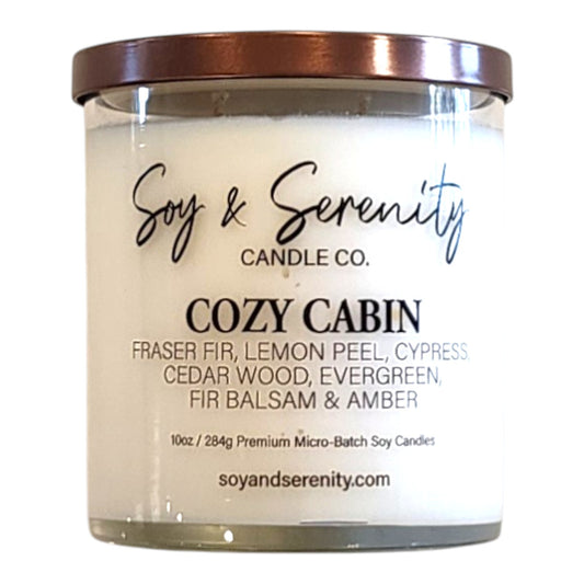 Cozy Cabin Christmas tree soy candle in a clear glass jar on a white background, winter pine candle.