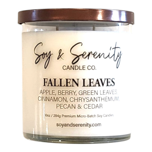 Fallen Leaves fall candle in a clear glass jar on a white background, earthy autumn soy candle.