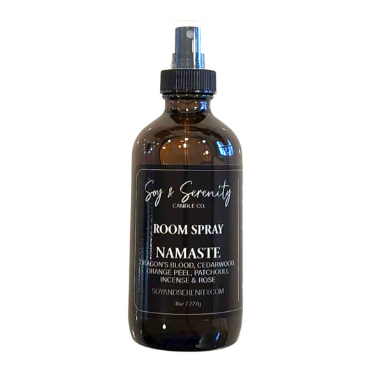 Room spray with dragon’s blood, cedarwood, orange peel, patchouli, incense, and rose notes on a white background, clean earthy home fragrance.