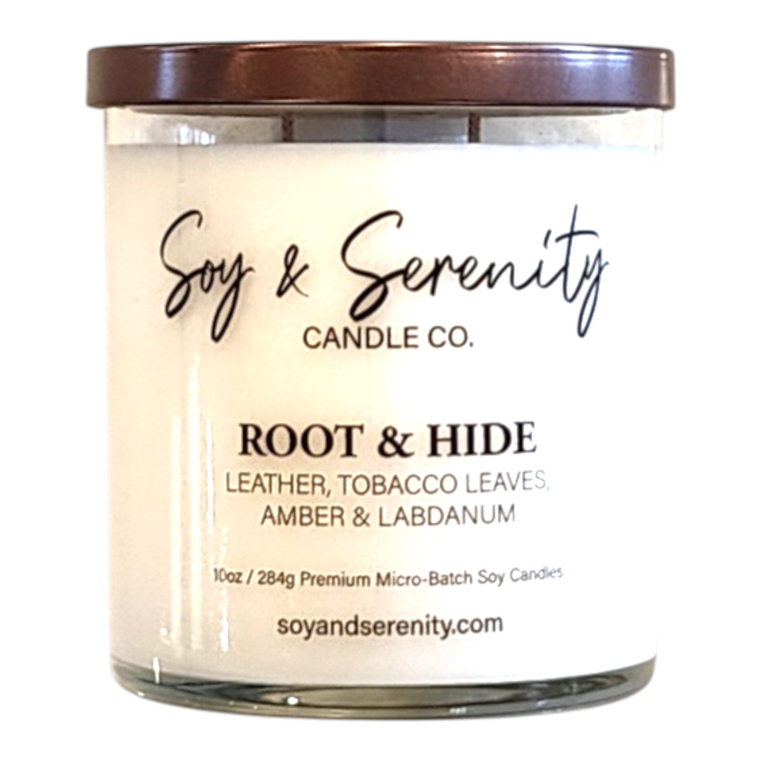 Root & Hide leather soy candle with tobacco, amber, and labdanum notes on a white background.