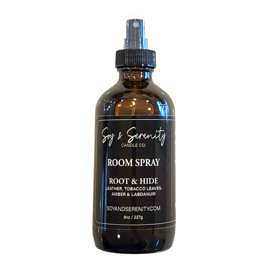 Room spray with leather, tobacco leaves, amber, and labdanum notes on a white background, clean masculine home fragrance.