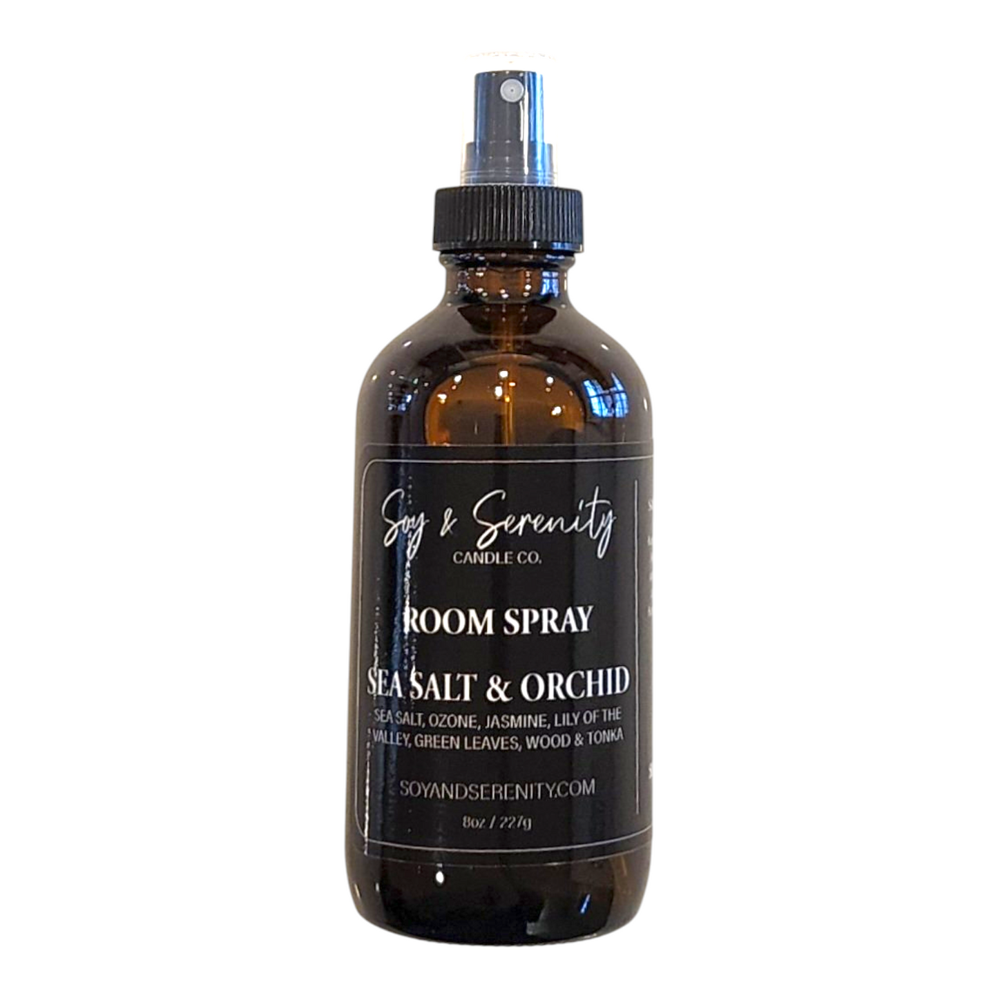 Sea Salt & Orchid room spray with sea salt, jasmine, lily of the valley, green leaves, wood, and tonka notes on a white background, clean coastal air freshener.