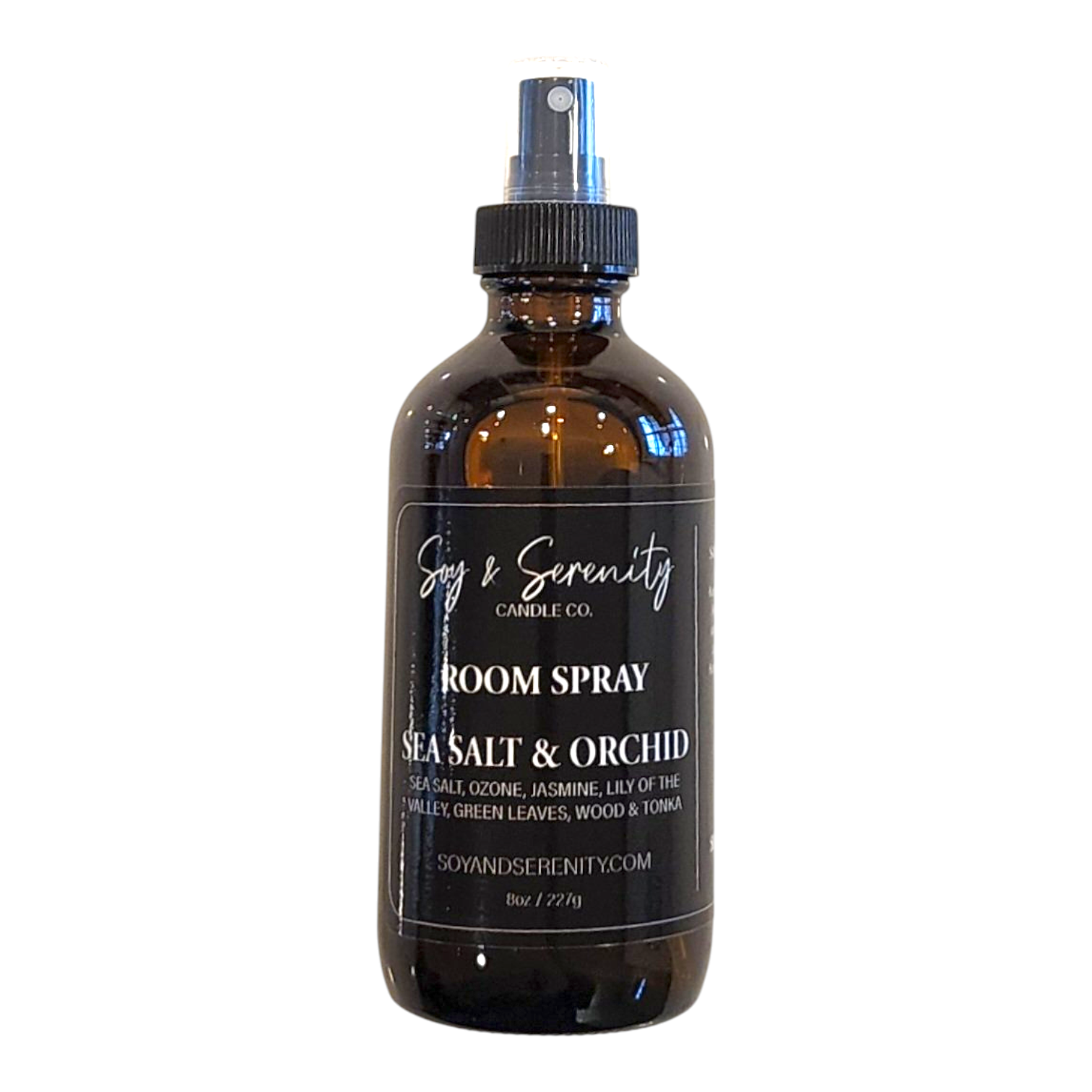 Sea Salt & Orchid room spray with sea salt, jasmine, lily of the valley, green leaves, wood, and tonka notes on a white background, clean coastal air freshener.